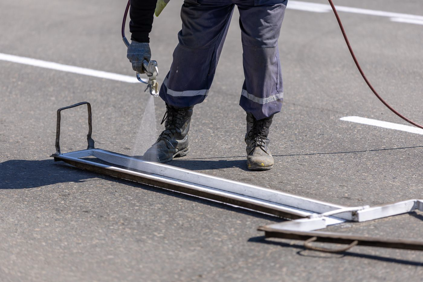 Road-marking specialist applying a precise white line