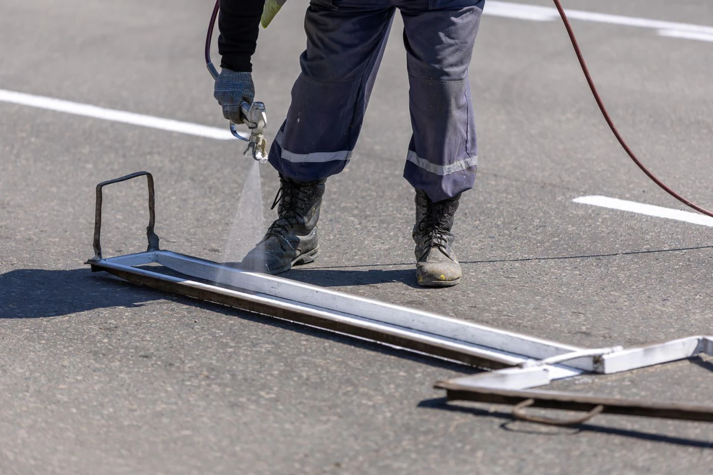 Road-marking specialist applying a precise white line